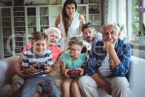 Family watching the kids playing video game