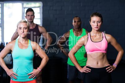 Determined athletes exercising in gym