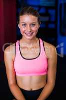 Portrait of fit smiling woman in gym