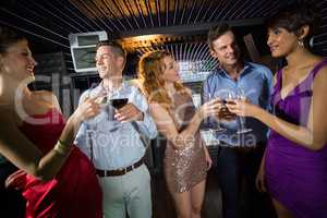 Group of friends toasting glasses of champagne and wine