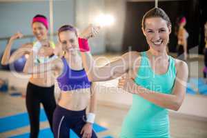 Group of women showing biceps