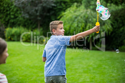 Kids playing with bubbles in the park