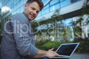 Portrait of business executive using laptop
