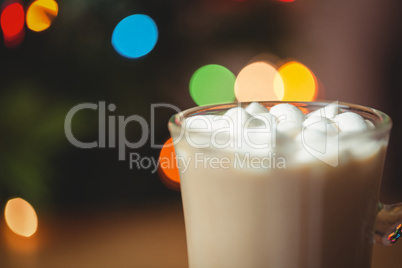 Cup of coffee with marshmallow on wooden table