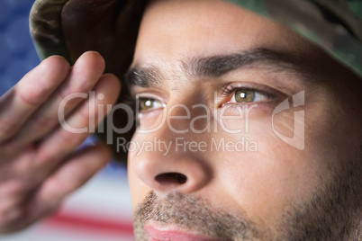 Confident soldier saluting