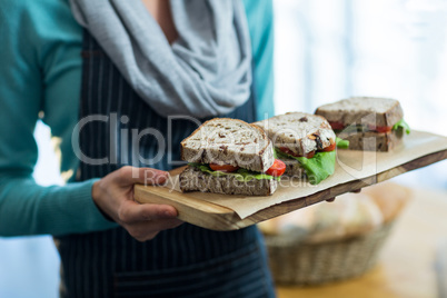 Waitress holding a tray with sandwiches in cafÃ?Â©