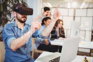 Businessman gesturing while using virtual reality headset