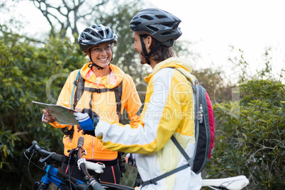 Biker couple interacting over map