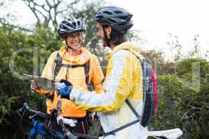 Biker couple interacting over map