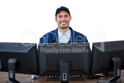 Portrait of happy security officer using computer
