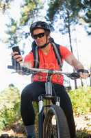 Mountain biker using mobile phone