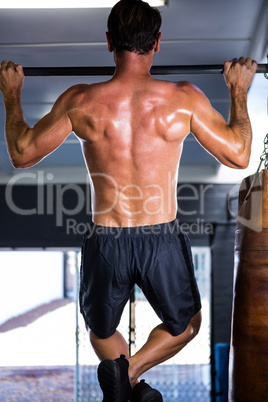 Rear view of athlete doing chin-ups