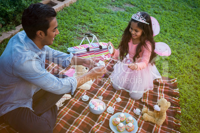 Father and daughter having toy tea party