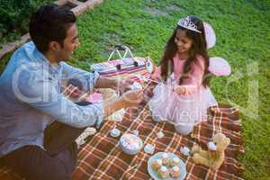 Father and daughter having toy tea party