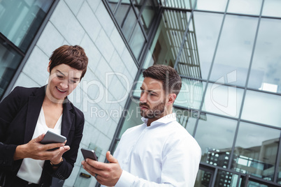 Businesspeople using mobile phone