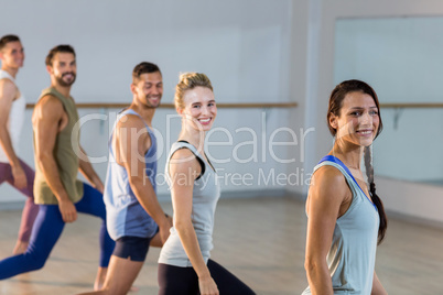 Group of fitness team performing stretching exercise