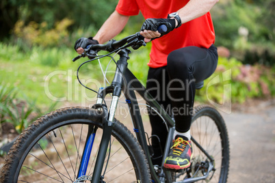 Male cyclist cycling in countryside