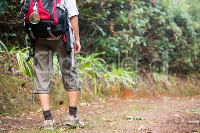 Female hiker walking in forest with backpack