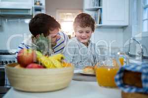 Father and son having breakfast in the kitchen