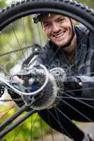 Male cyclist repairing his mountain bike