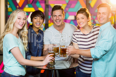 Group of friends having glass of beer in party