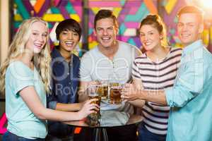 Group of friends having glass of beer in party