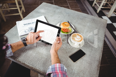 Hands of man using digital tablet