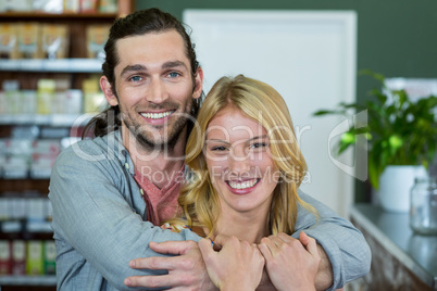 Portrait of happy couple embracing each other in a coffee shop