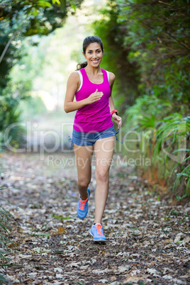 Woman jogging through a forest