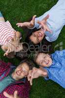Happy family lying on grass in park