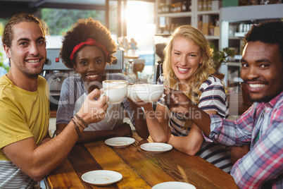 Group of happy friends holding cup of coffee