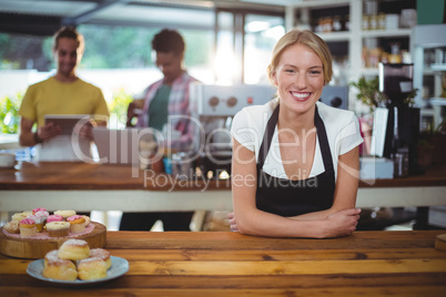 Portrait of waitress standing behind the counter