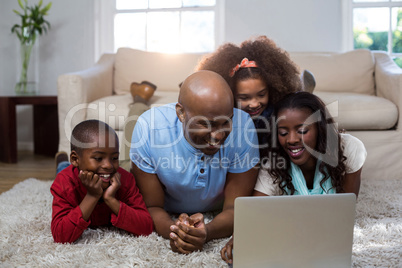 Happy family using laptop