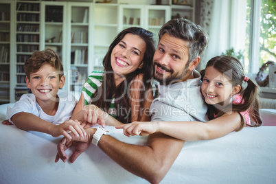 Happy family sitting on sofa