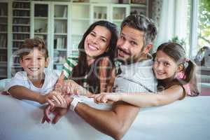 Happy family sitting on sofa