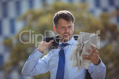 Handsome businessman reading newspaper