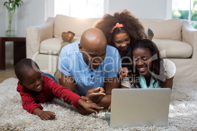 Happy family using laptop