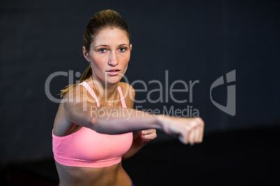 Woman practicing boxing in fitness studio