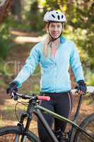 Portrait of female mountain biker with bicycle