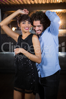 Cute couple dancing together on dance floor