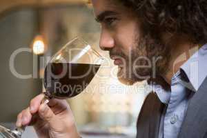 Businessman having glass of red wine