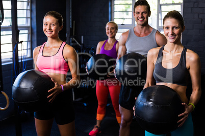Happy athletes exercising with fitness ball