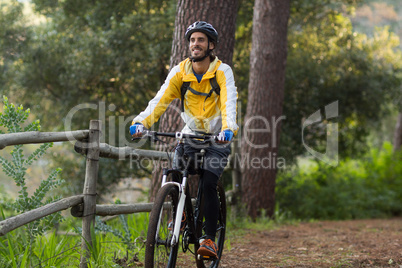 Male biker cycling in countryside