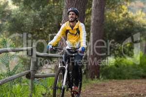 Male biker cycling in countryside