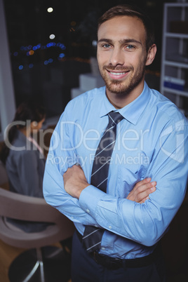 Business executive standing with arms crossed