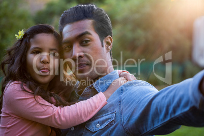 Father and daughter taking a selfie