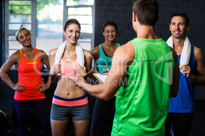 Fitness instructor discussing with happy people