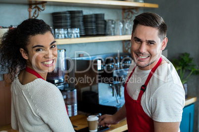 Smiling waitress and waiter in cafe