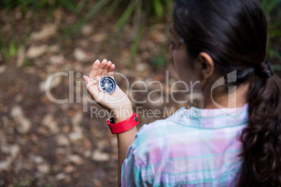 Female hiker looking at compass
