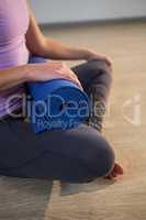 Woman holding exercise mat